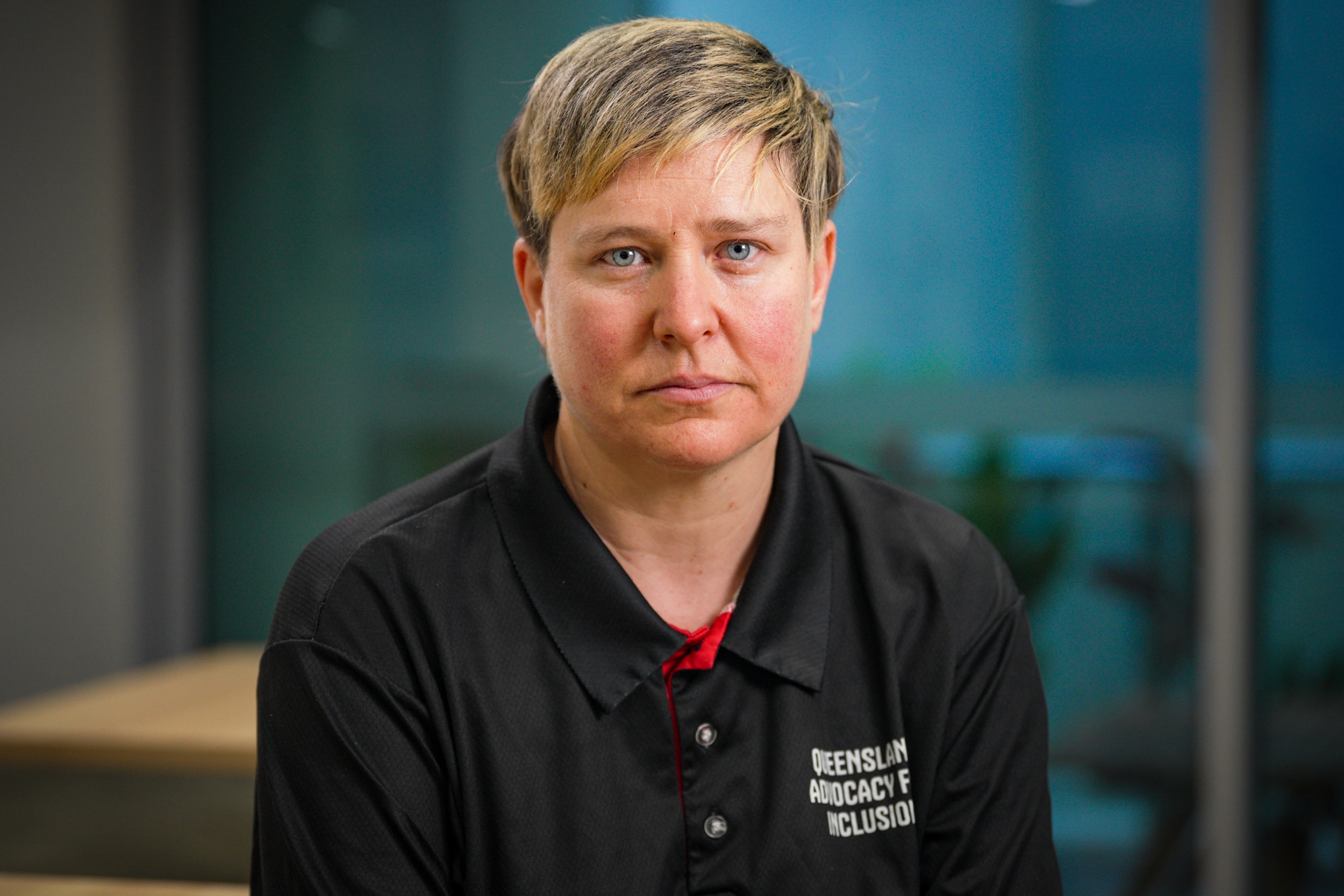 A white woman with short blonde hair sitting in an office space