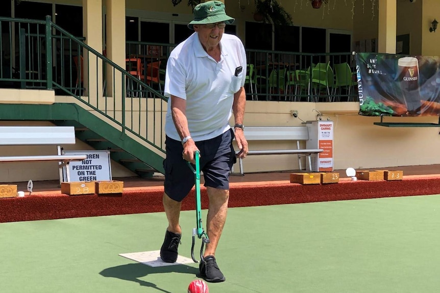 A man uses a device to help him release his bowl