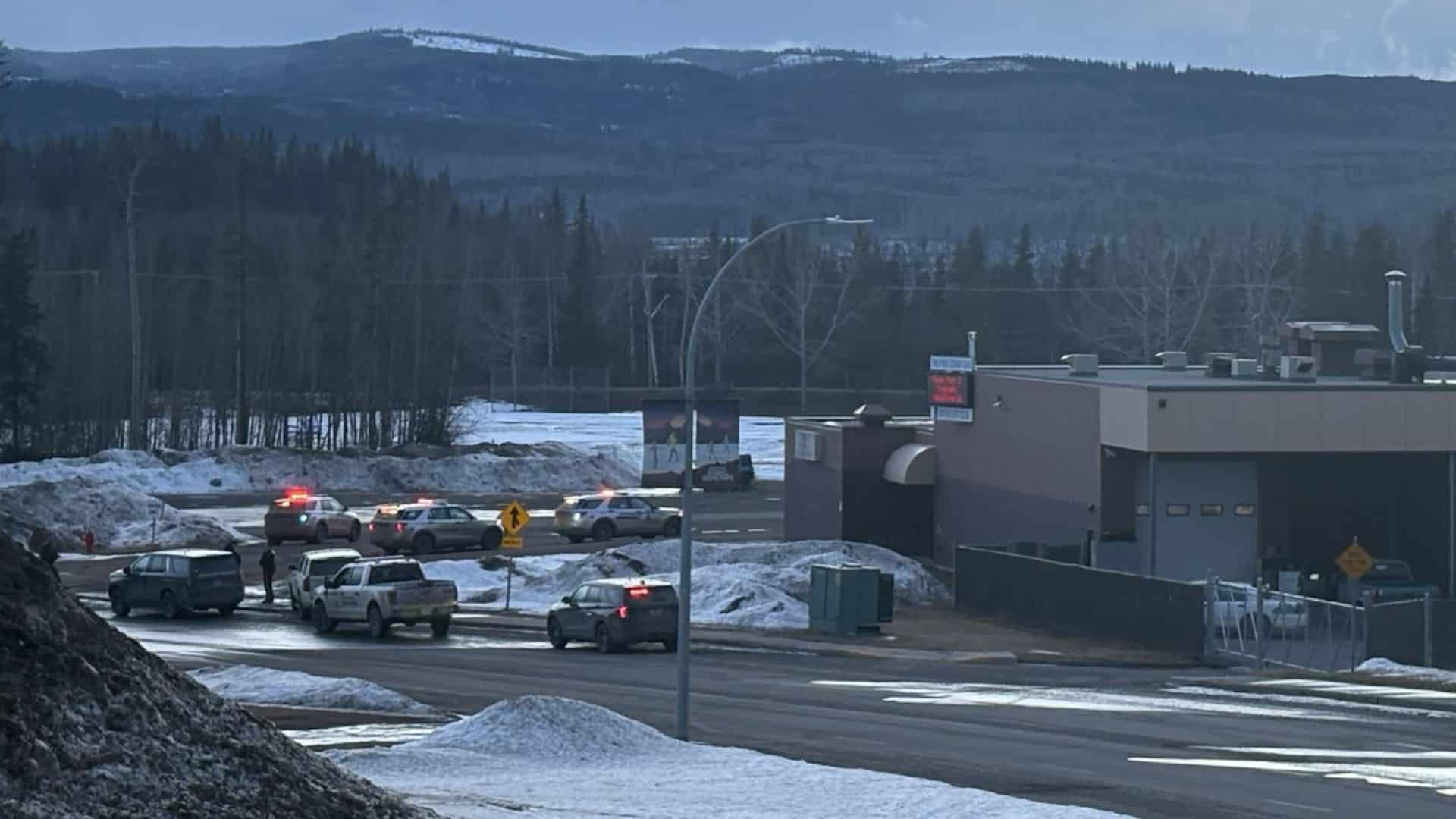 Canadian police vehicles outside a high school.