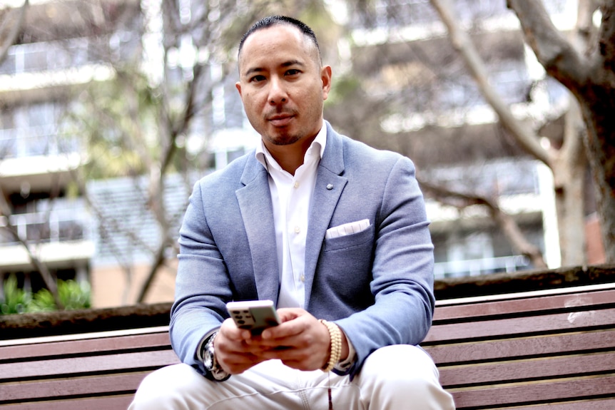 a man in a suit on a park bench