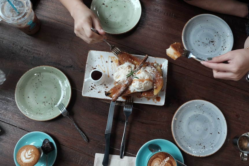 Bird's eye view of people sharing a dessert