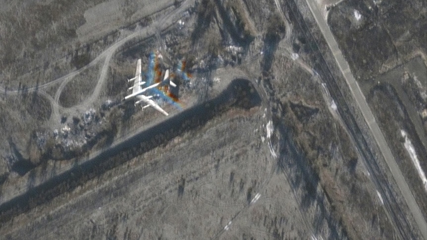 A satellite image from an air base. A large air plane is pictured. 