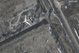 A satellite image from an air base. A large air plane is pictured. 