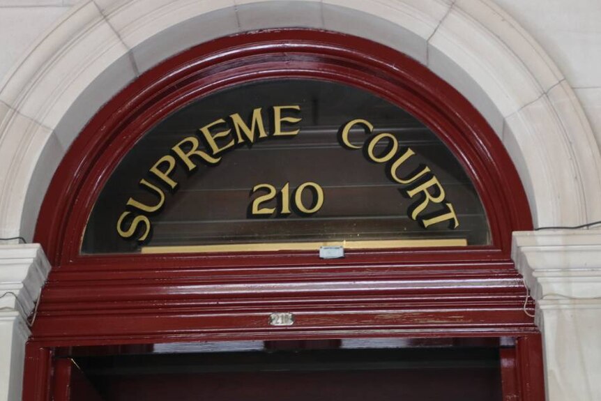 A Supreme Court sign above a door.