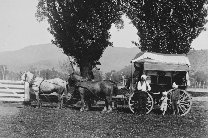 An historic photograph of a hawker and his wagon.