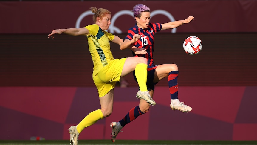 Clare Polkinghorne (left) and Megan Rapinoe (right) battle for the ball.