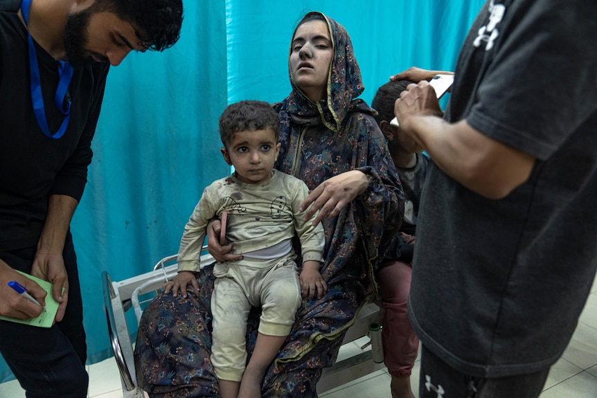 A woman holds a child in a hospital 