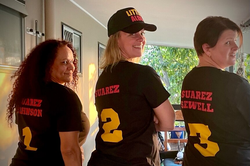 Three ladies in shirts with their names on them