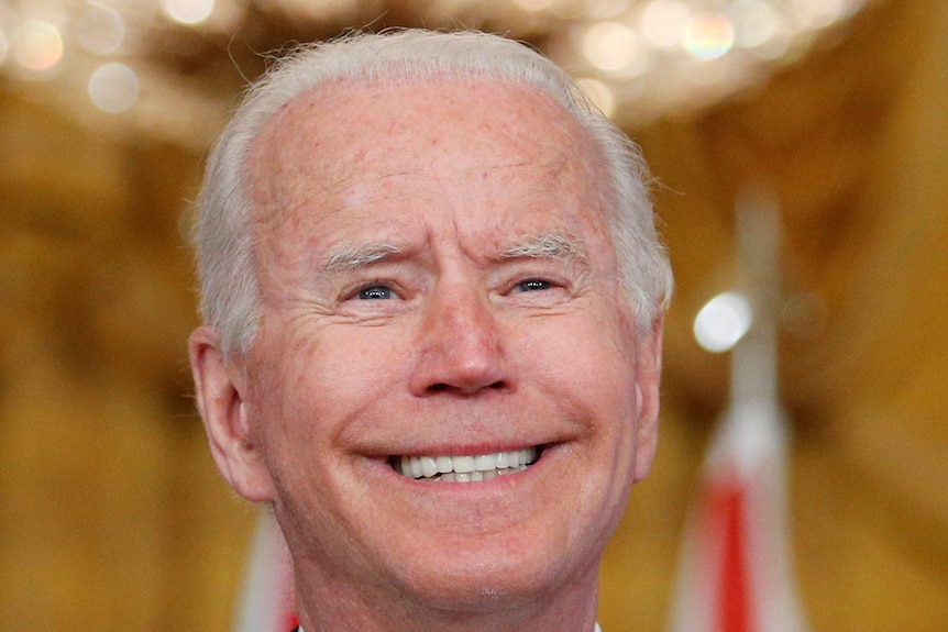 A close up of Joe Biden's smiling face 