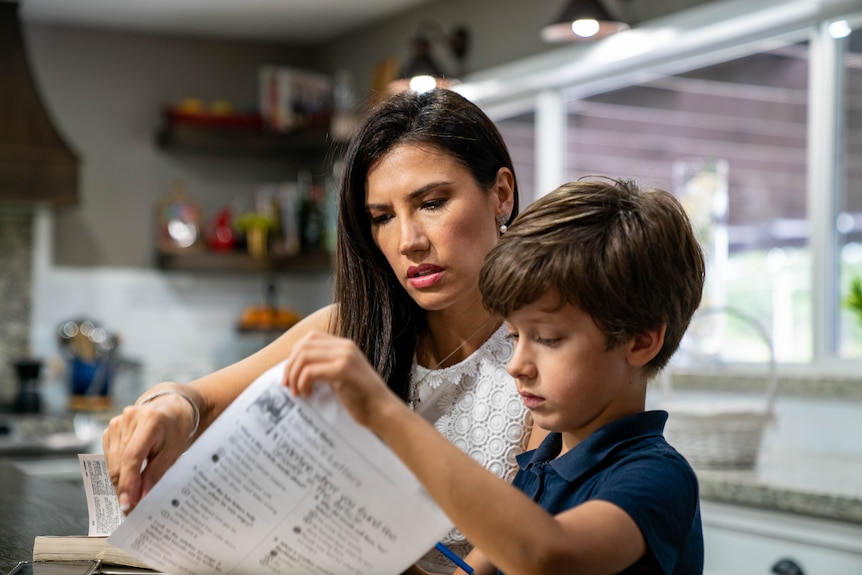 A woman sits with her son.