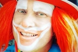 Smiling photo of Peter Bissell, dressed as his clown character 'Peebo'
