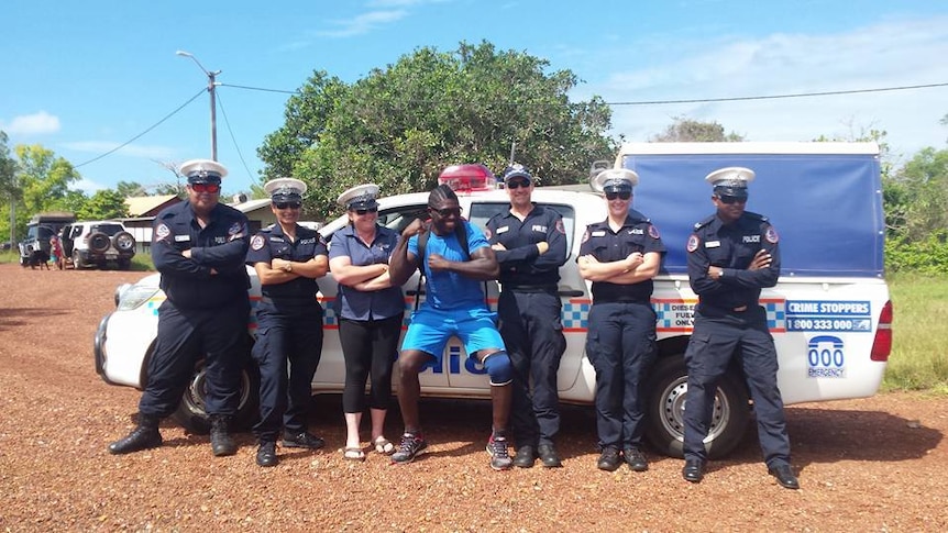 police officers and a DJ in front of a police car