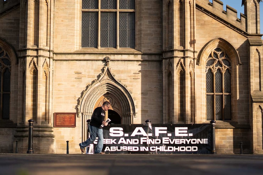 Dave Sharp sets up a banner.