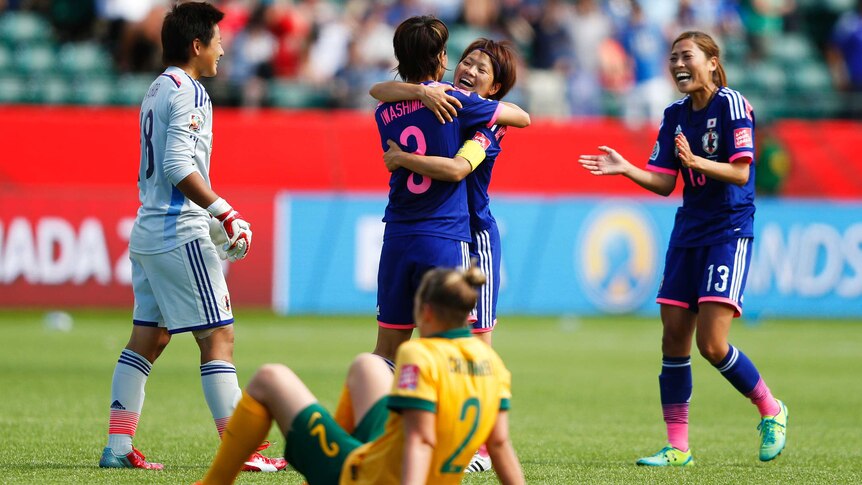 Larissa Crummer sits as Japan players celebrate