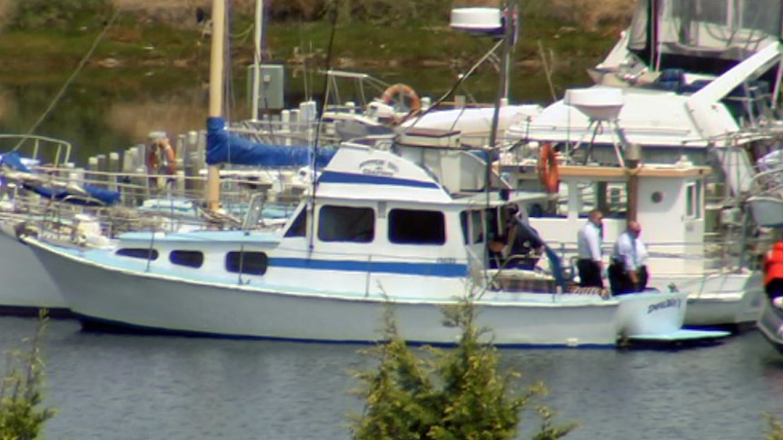 Hobart police on a boat where two bodies were found.