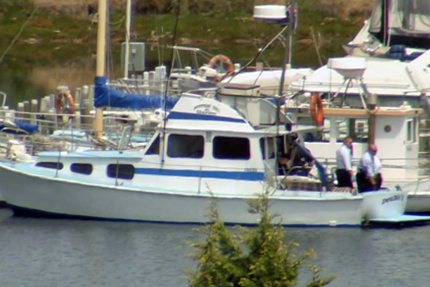 Hobart police on a boat where two bodies were found.