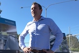 Mark McGowan stands with hands on hips.