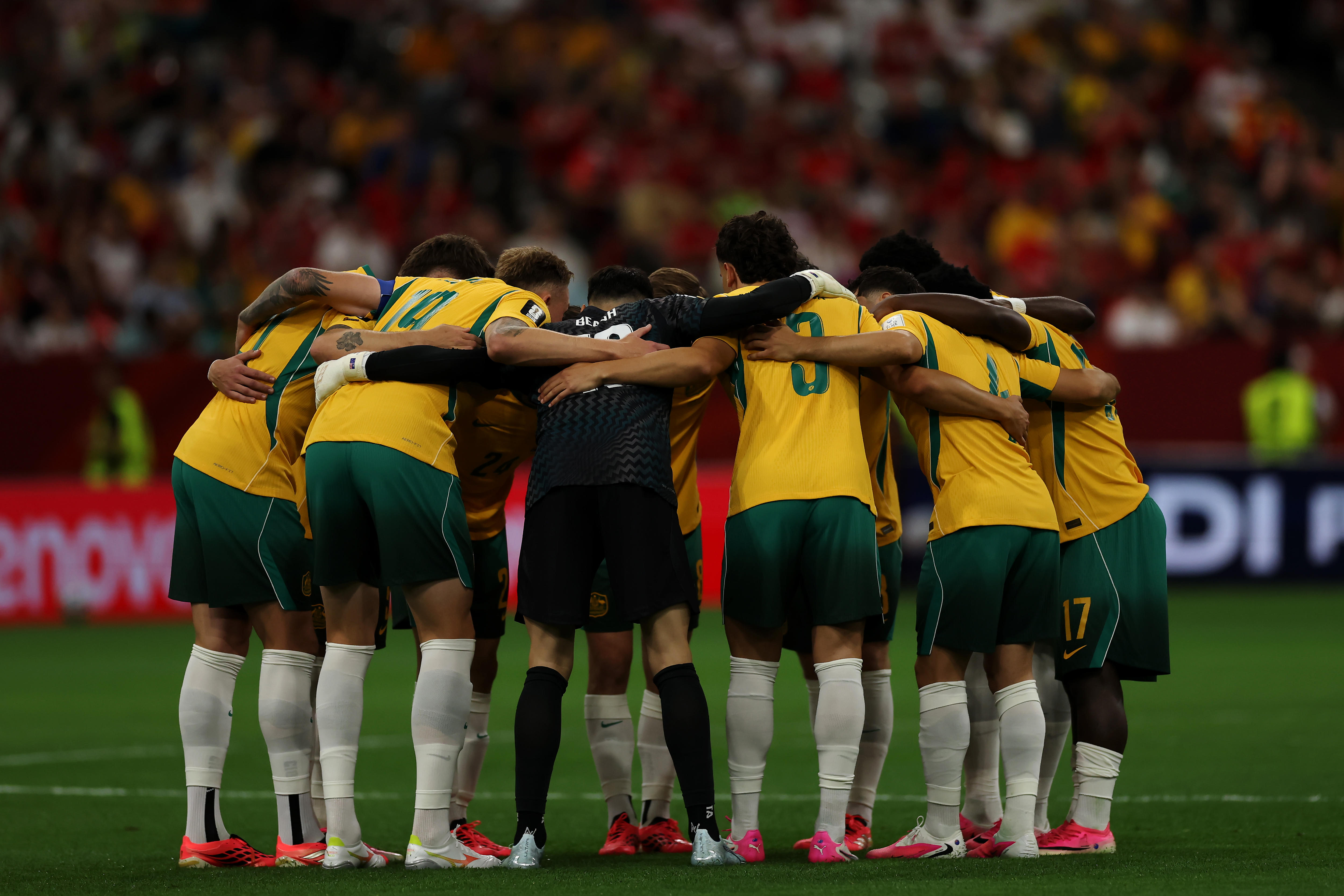 The Socceroos team in a huddle