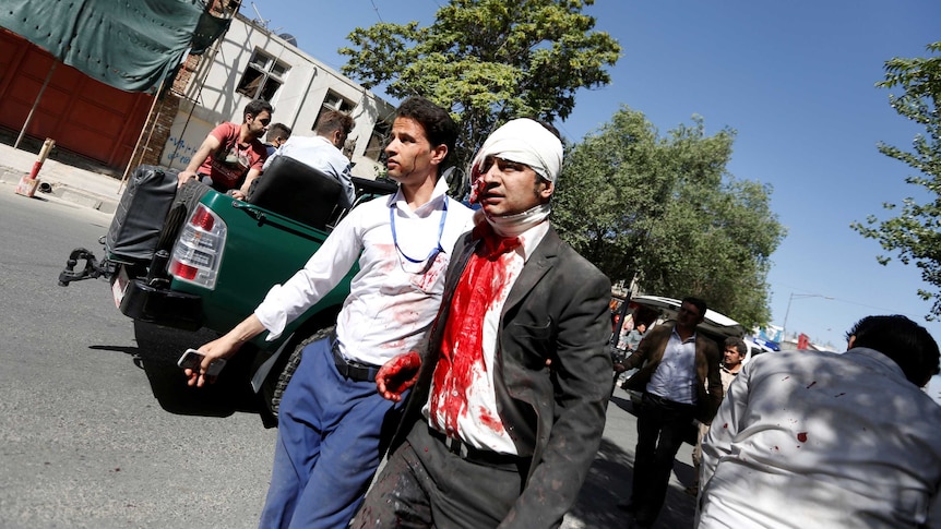 An injured man arrives to a hospital after a blast in Kabul.