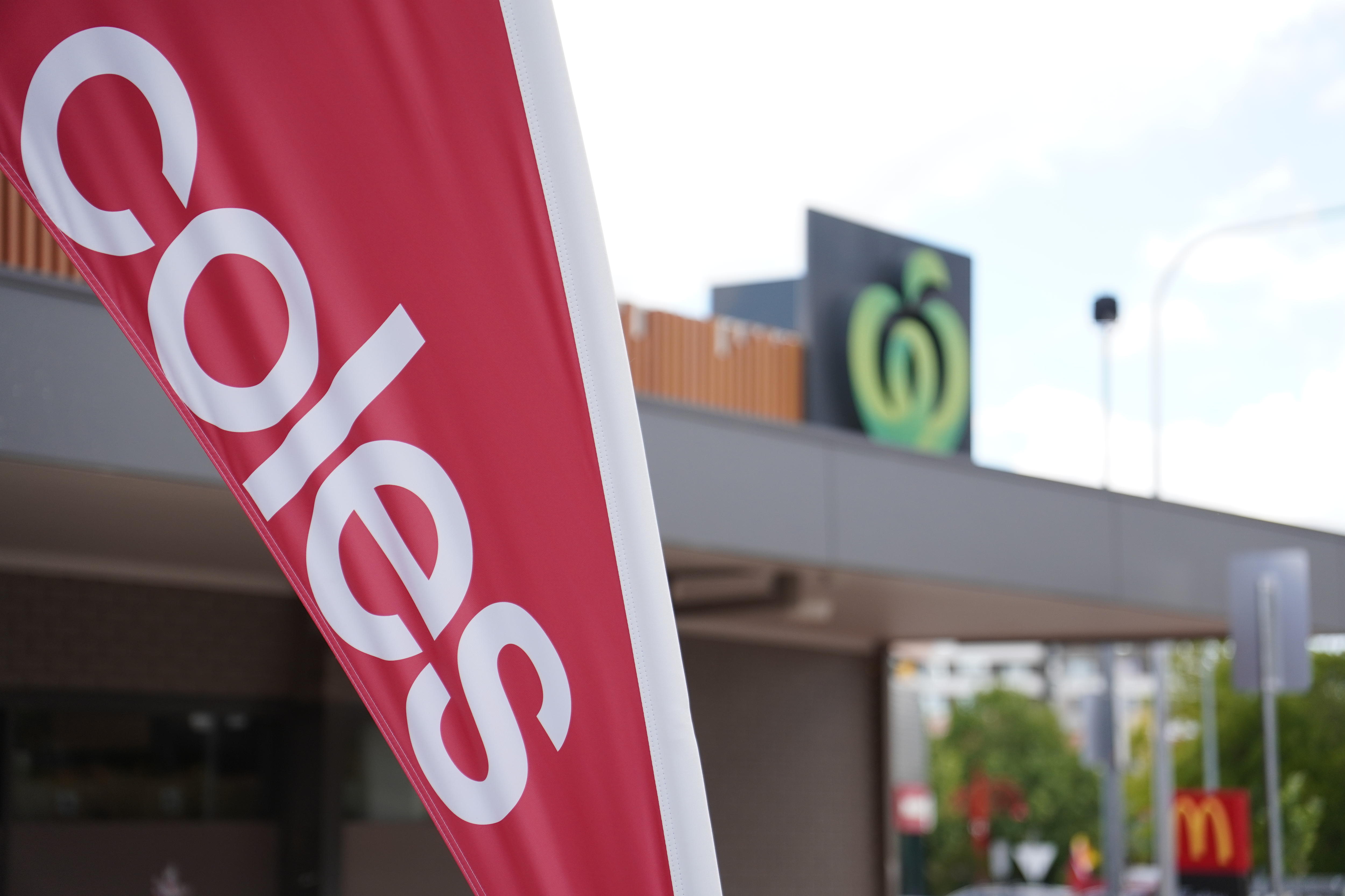 Coles and Woolworths branding outside neighbouring supermarkets