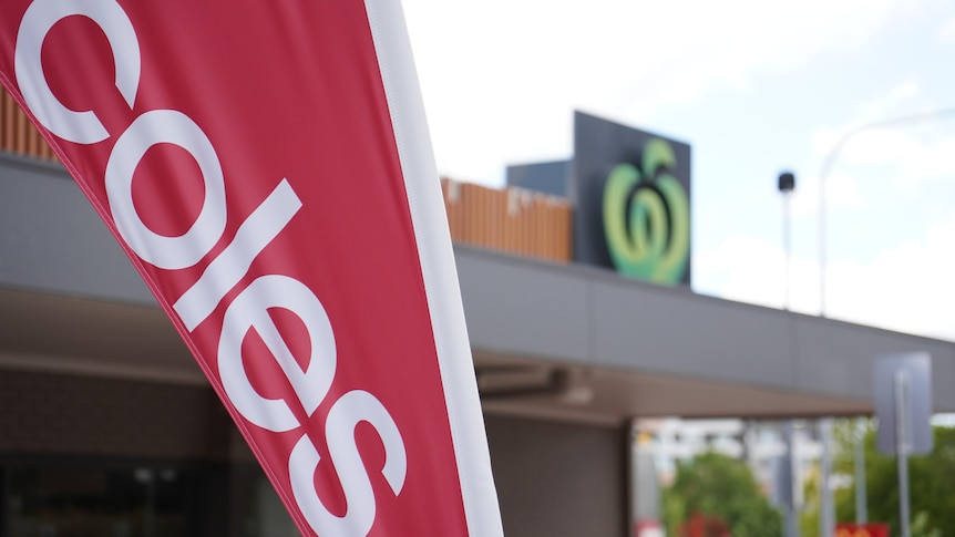 Coles and Woolworths branding outside neighbouring supermarkets