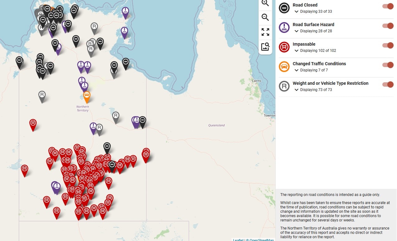 A screenshot of Road Report NT showing many red markers around Central Australia indicating impassable roads after heavy rains 