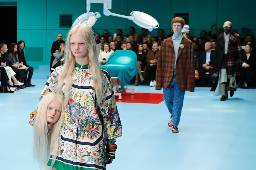 Model parades carries fake head of herself during Milan Fashion Week