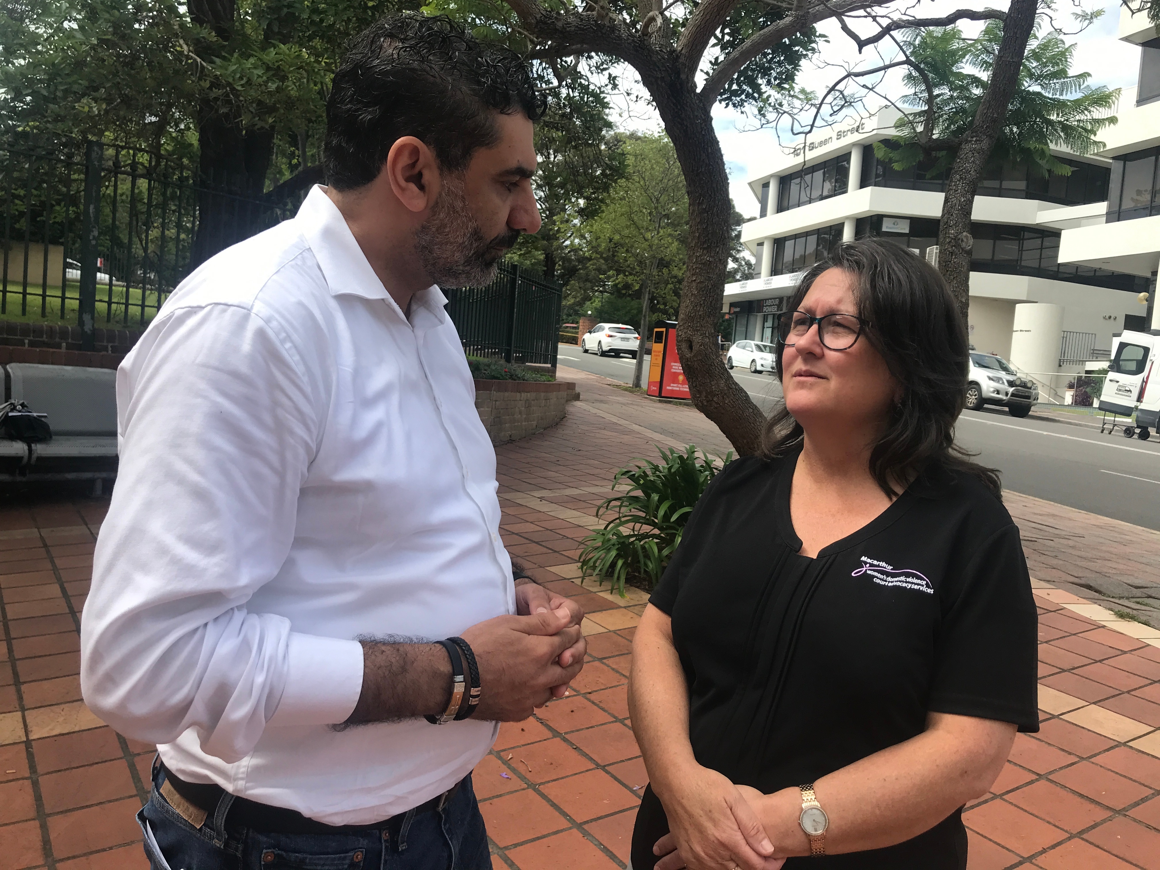 Man and woman talking outside court 