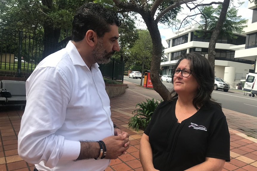 Man and woman talking outside court 