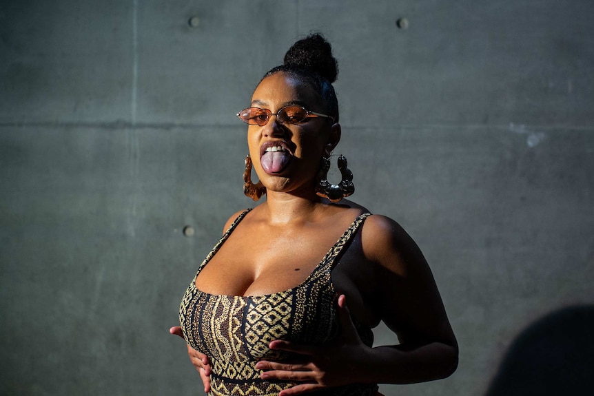 CC Banks stands with her tongue sticking-out for a portrait photo at Carriageworks in 2019.