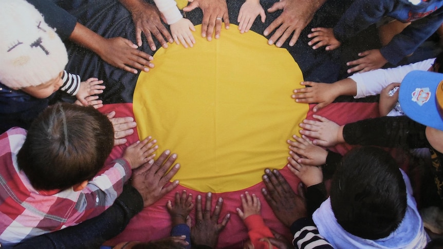 Aboriginal flag with children's hands