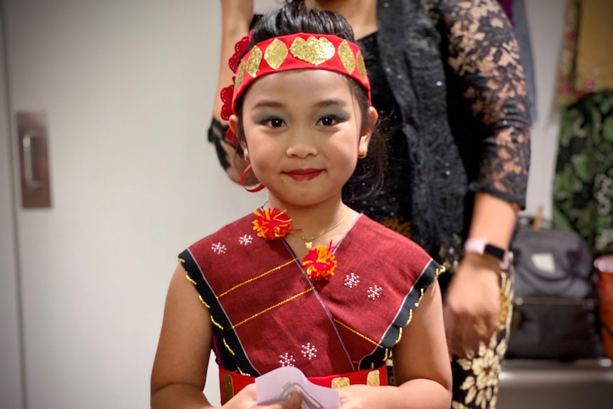 A child wearing traditional Indonesian costume