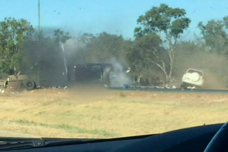 A screenshot of a car crash on a country road.