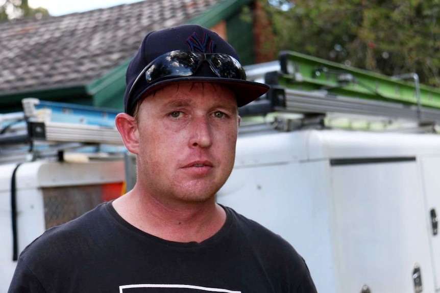 Robert Mutch standing in front of a truck.