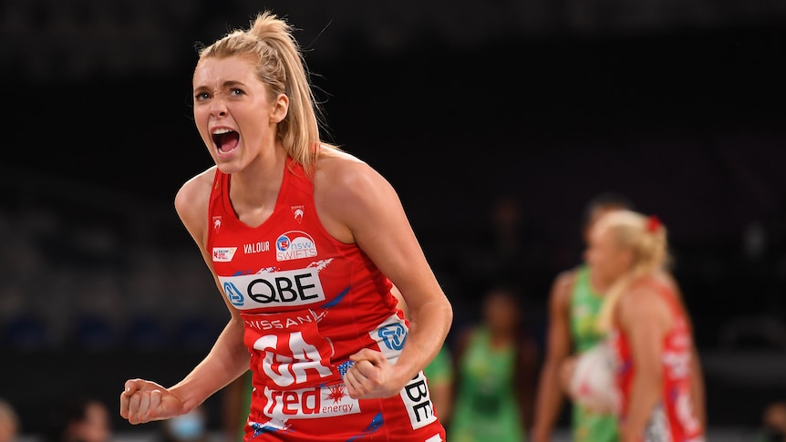A NSW Swifts Super Netball players yells out as she celebrates her side's win over the West Coast Fever.