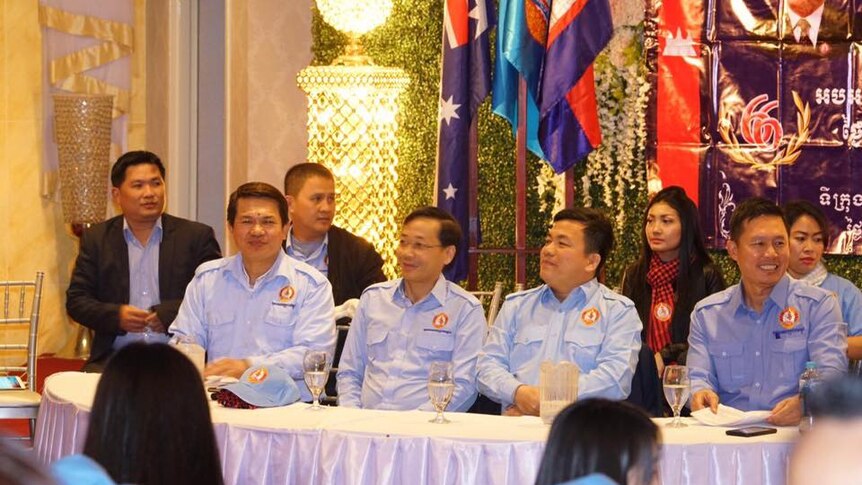 Koy Kuong, pictured front row, second from the right, in political uniform at a youth event.