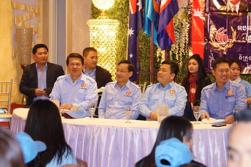 Koy Kuong, pictured front row, second from the right, in political uniform at a youth event.