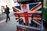 Postcards featuring the World War II British slogan "Keep Calm and Carry On" are seen outside a newsagents in London