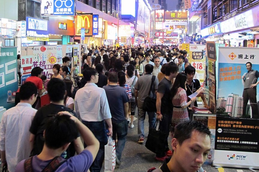People make their way through the bustling Hong Kong district of Mong Kok.