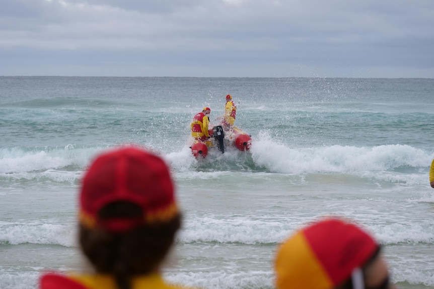 Inflatable rescue boat and surf lifesavers on the ocean.