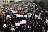 Iranian protesters chant slogans at a rally in Tehran