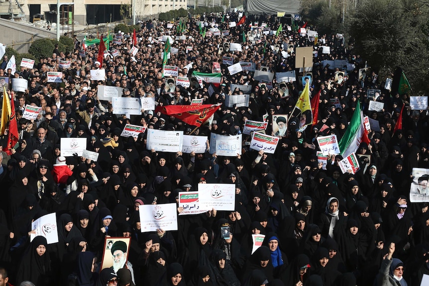 Iranian protesters chant slogans at a rally in Tehran