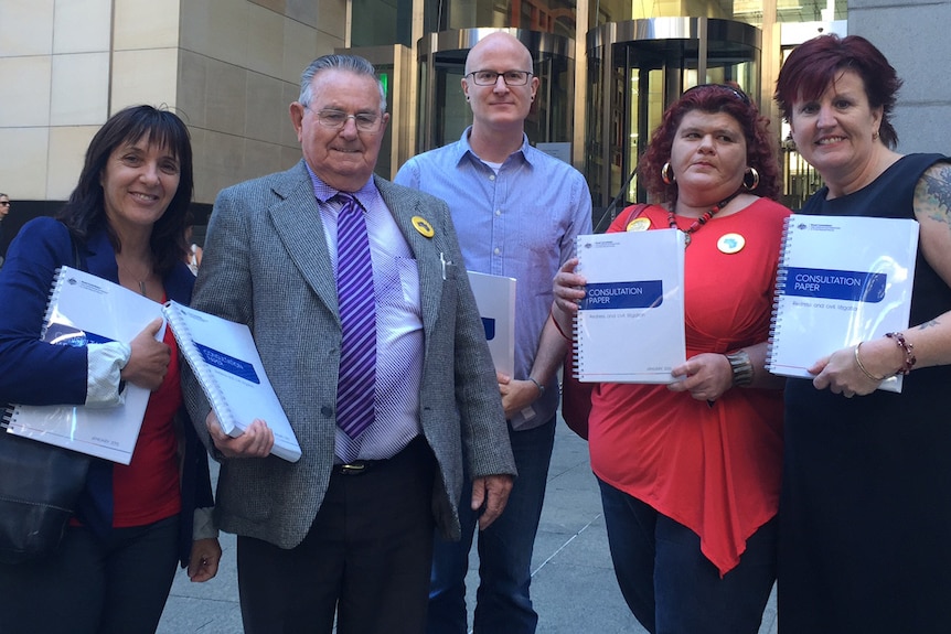 Survivors of child sexual abuse and their supporters gather outside the royal commission after the release of the paper.