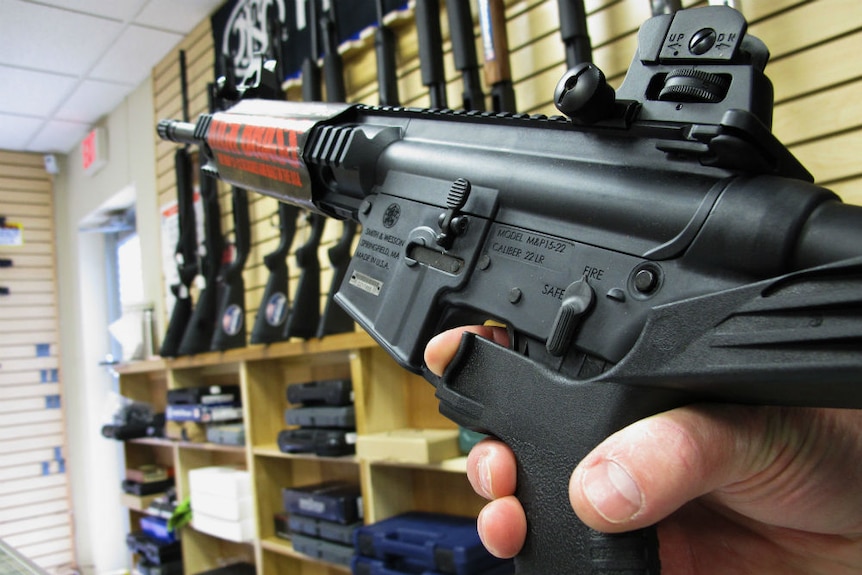 An employee of North Raleigh Guns demonstrates how a "bump stock" works.