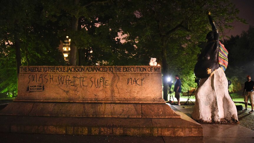 The empty pedestal of the Jackson and Lee monument with the words "smash white supremacy" written on it.