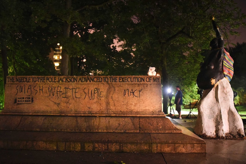 The empty pedestal of the Jackson and Lee monument with the words "smash white supremacy" written on it.