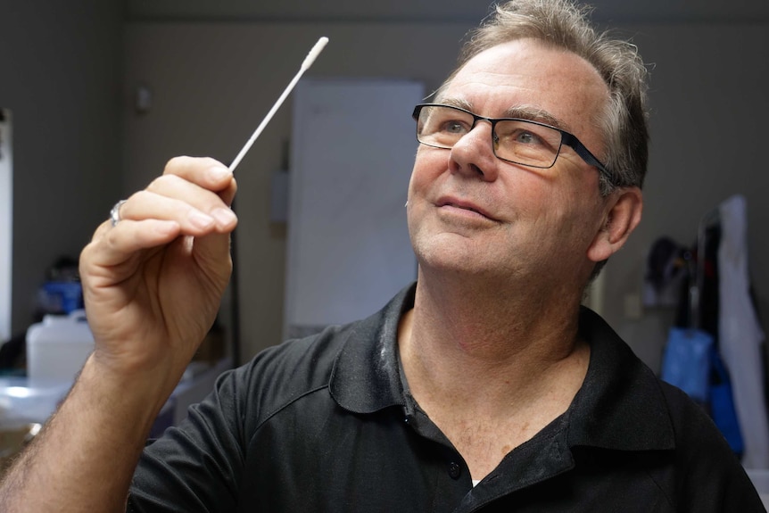 3D Printing Studios CEO Howard Wood holds a swab.