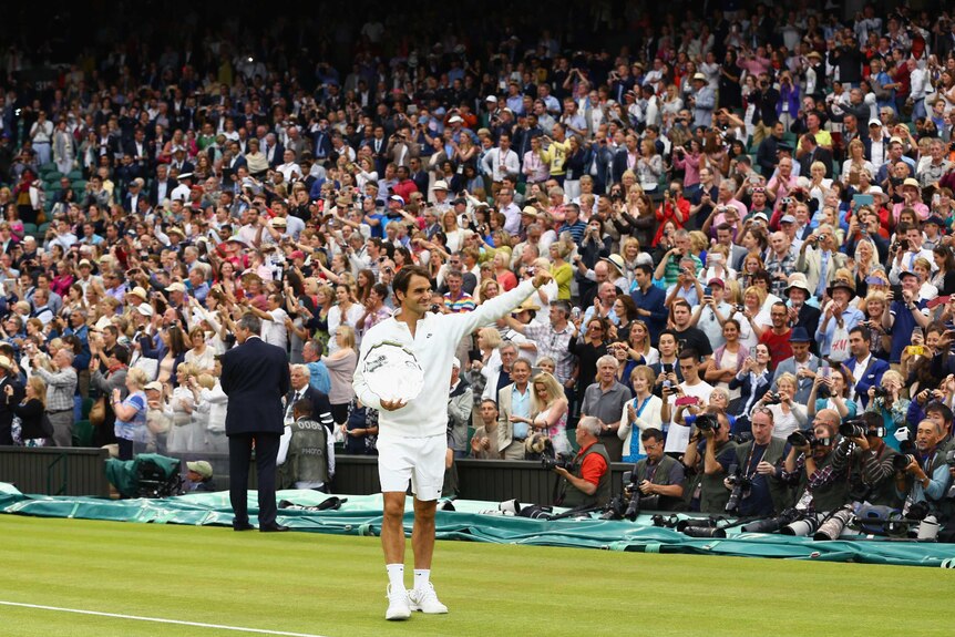 Roger Federer waves to the crowd after Wimbledon final