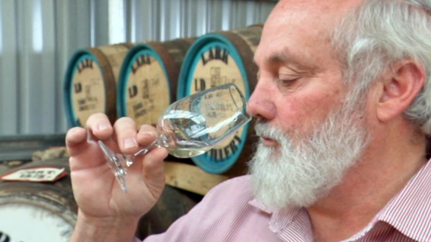 Tasmanian distiller Bill Lark sips a small glass of gin.