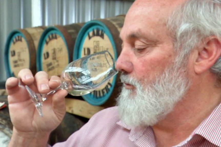 Tasmanian distiller Bill Lark sips a small glass of gin.